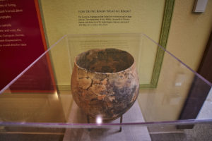 A bronze-colored, cracked but intact Carolina Algonquian cooking pot on display at the Visitor Center at Fort Raleigh National Historic Site.