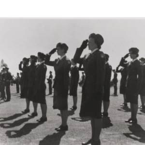 Group of Women Airforce Service Pilots (WASPs) saluting on field.