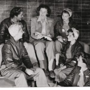 Six Women Air Force Service Pilots (WASPs) sitting in a group talking.