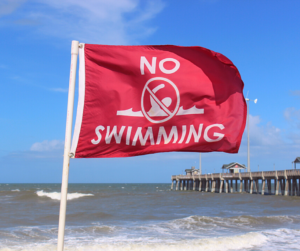 Red No Swimming Flag on Beach