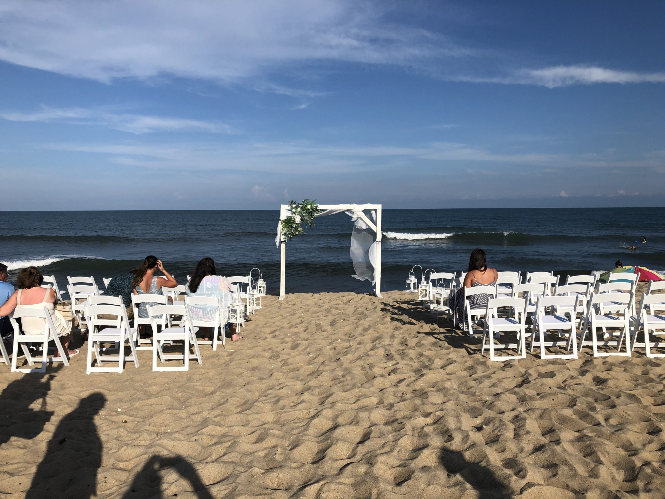 A wedding arch and chairs set up on the beach at Cape Hatteras National Seashore.