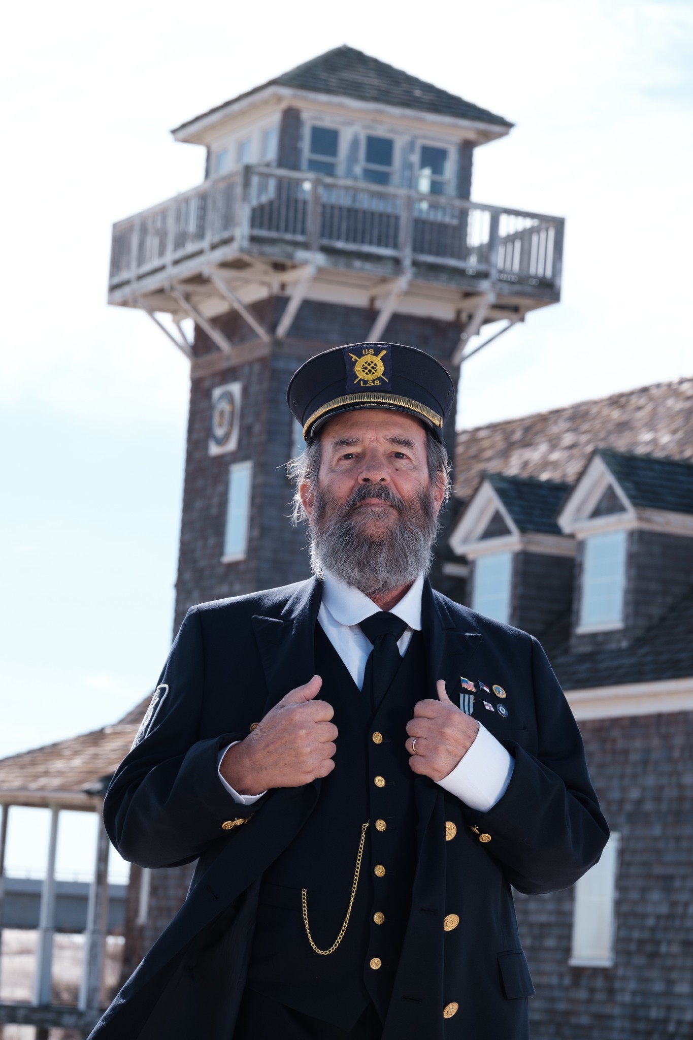 James Charlet dressed as a lighthouse keeper standing in front of the Oregon Inlet Lifesaving Station.