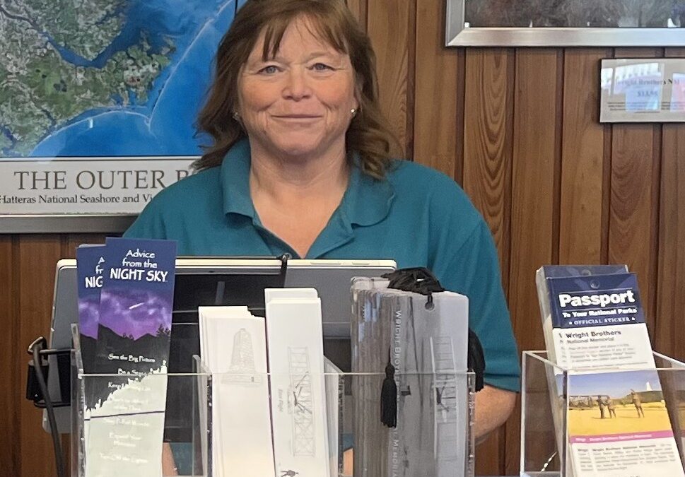 Kelly Hartman behind the counter of the Outer Banks Forever store at Wright Brothers National Memorial.