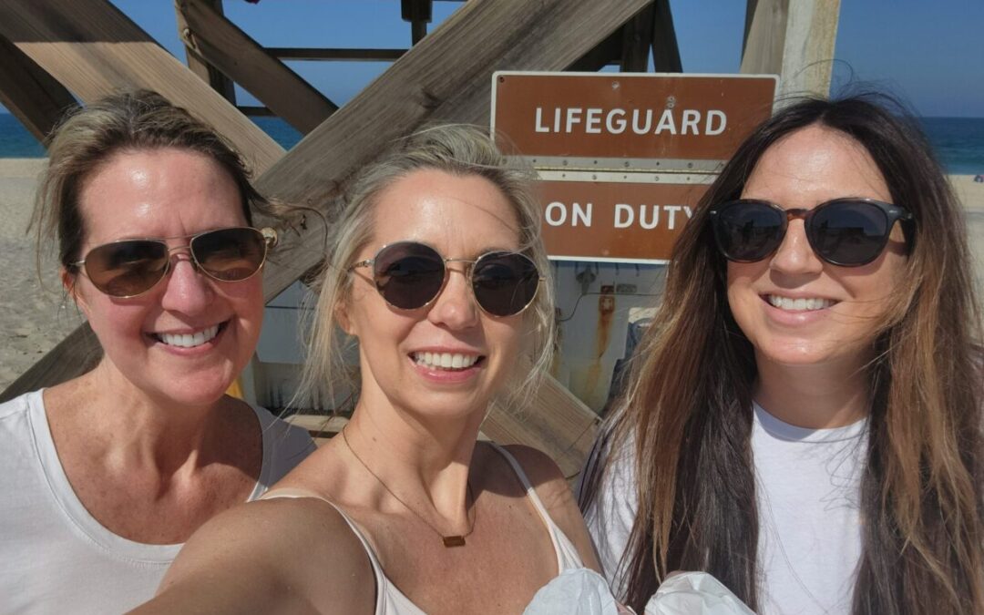 Shannon Painter (center) with two coworkers from Sun Realty attending a beach cleanup on Cape Hatteras National Seashore.